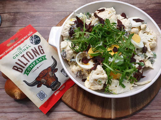 Mock potato salad with biltong, featuring the final dish alongside biltong, perfect for an easy and tasty salad recipe