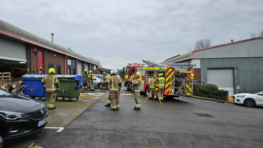 Firefighters in protective gear stand outside The Original Biltong Company’s production facility